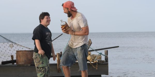 Photo of the movie, Peanut Butter Falcon - Zack Gottsagen playing a young man with down syndrome smiling and laughing with Shia LaBeouf playing a fisherman